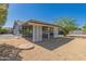 Exterior shot of a backyard featuring a patio and desert landscaping at 12021 S Tomi Dr, Phoenix, AZ 85044