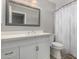 Bathroom with white vanity, large mirror, and patterned shower curtain at 12021 S Tomi Dr, Phoenix, AZ 85044