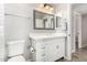 Bright bathroom with a vanity, mirror, and convenient toilet accessories at 12021 S Tomi Dr, Phoenix, AZ 85044