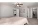 Neutral bedroom featuring a ceiling fan and doorways to the closet and bathroom at 12021 S Tomi Dr, Phoenix, AZ 85044