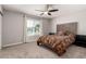 Comfortable bedroom with a ceiling fan and a view outside the window at 12021 S Tomi Dr, Phoenix, AZ 85044