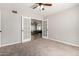 Neutral bedroom features carpet, a ceiling fan, and doors to another room at 12021 S Tomi Dr, Phoenix, AZ 85044