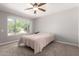 A bright bedroom with a large window and neutral color palette at 12021 S Tomi Dr, Phoenix, AZ 85044