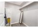 A walk-in closet with neutral walls, shelving, and storage at 12021 S Tomi Dr, Phoenix, AZ 85044