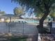 Community pool with shade, lounge chairs, and lush landscaping for relaxing at 12021 S Tomi Dr, Phoenix, AZ 85044