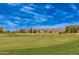 Expansive golf course view with mountain backdrop and wispy clouds on a bright, sunny day at 12021 S Tomi Dr, Phoenix, AZ 85044