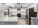 Modern kitchen features white cabinets, stainless steel appliances, and a bright, stylish design at 12021 S Tomi Dr, Phoenix, AZ 85044