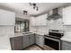 Updated kitchen features modern appliances, subway tile backsplash, and ample counter space at 12021 S Tomi Dr, Phoenix, AZ 85044