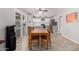 Bright kitchen and dining area featuring modern white cabinets, stainless steel appliances, and wood dining table at 12021 S Tomi Dr, Phoenix, AZ 85044