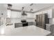 Bright kitchen with stainless steel appliances, light countertops, and two-tone cabinetry at 12021 S Tomi Dr, Phoenix, AZ 85044