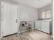 Bright laundry room with modern washer and dryer on wood-look vinyl floors at 12021 S Tomi Dr, Phoenix, AZ 85044