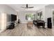Spacious living room featuring modern floors, ceiling fan, large window, and stylish furnishings at 12021 S Tomi Dr, Phoenix, AZ 85044