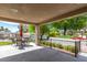 Covered patio seating near the pool and gardens, offering a perfect blend of relaxation and nature at 12021 S Tomi Dr, Phoenix, AZ 85044