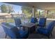 Relaxing covered patio with comfortable seating and a cozy fire pit near the community pool at 12021 S Tomi Dr, Phoenix, AZ 85044