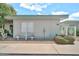 Charming single-story home with white exterior, front yard decor, and well-maintained landscaping at 13207 N 98Th Ave # L, Sun City, AZ 85351