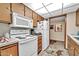 Efficient kitchen with white appliances, ample storage, and a functional layout at 13207 N 98Th Ave # L, Sun City, AZ 85351