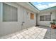 Relaxing outdoor patio with tile flooring, screen door, and ample natural light at 13207 N 98Th Ave # L, Sun City, AZ 85351