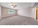 A large bedroom offers neutral carpet and a ceiling fan, providing a calming space at 13224 N 98Th Ave # L, Sun City, AZ 85351
