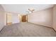 This carpeted bedroom leads to a bathroom and a walk-in closet at 13224 N 98Th Ave # L, Sun City, AZ 85351