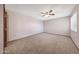 A bedroom offers neutral carpet and a ceiling fan, providing a calming space at 13224 N 98Th Ave # L, Sun City, AZ 85351