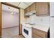 Well-equipped kitchen with white appliances and view into the living room at 13224 N 98Th Ave # L, Sun City, AZ 85351
