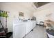Well-equipped laundry room featuring a washer, dryer, utility sink, and ample space at 13224 N 98Th Ave # L, Sun City, AZ 85351