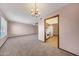 Cozy living room flowing into the kitchen, featuring a classic chandelier at 13224 N 98Th Ave # L, Sun City, AZ 85351