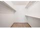 A walk-in closet featuring carpeted floors, white walls and shelving at 13224 N 98Th Ave # L, Sun City, AZ 85351