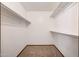 A walk-in closet featuring carpeted floors, white walls and shelving at 13224 N 98Th Ave # L, Sun City, AZ 85351