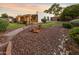 Landscaped backyard featuring desert landscaping, manicured lawn, and patio with a covered porch at 14029 N Burning Tree Pl, Phoenix, AZ 85022