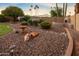 Desert landscaping in the backyard featuring a bird bath and orange trees at 14029 N Burning Tree Pl, Phoenix, AZ 85022