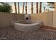 Backyard featuring a built-in BBQ island with desert landscaping and palm trees at 14029 N Burning Tree Pl, Phoenix, AZ 85022