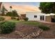 Backyard with desert landscaping featuring a manicured lawn, mature shrubs, and an orange tree at 14029 N Burning Tree Pl, Phoenix, AZ 85022