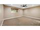 Spacious carpeted bedroom with a ceiling fan and a small window at 14029 N Burning Tree Pl, Phoenix, AZ 85022