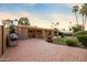 View of the side of the home with a paver patio, manicured lawn, and desert landscaping at 14029 N Burning Tree Pl, Phoenix, AZ 85022
