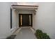 View of front door entrance with tile roofing and decorative window at 14029 N Burning Tree Pl, Phoenix, AZ 85022