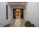 View of the front door, looking into the foyer area with hard wood flooring and decorative rug at 14029 N Burning Tree Pl, Phoenix, AZ 85022