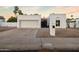 Charming single-story home featuring a two-car garage, gated front entry, and low-maintenance desert landscaping at 14029 N Burning Tree Pl, Phoenix, AZ 85022