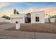 A view of the single-story home with desert landscaping, a two-car garage, and a gated entry way at 14029 N Burning Tree Pl, Phoenix, AZ 85022