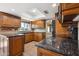 A well-lit kitchen features wood cabinets, granite counters, and modern fixtures beneath a skylight at 14029 N Burning Tree Pl, Phoenix, AZ 85022