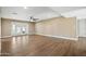 Spacious living room with wood flooring, fan and patio access at 14029 N Burning Tree Pl, Phoenix, AZ 85022