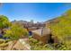 Beautiful condo community featuring well-maintained landscaping and tile roofs under a bright blue sky at 1411 E Orangewood Ave # 237, Phoenix, AZ 85020