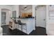 Convenient breakfast bar with stools connecting the kitchen and dining spaces, with open sightlines to other rooms at 1411 E Orangewood Ave # 237, Phoenix, AZ 85020