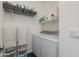 Functional laundry room with a washer, dryer, and storage shelves, offering convenience and organization at 1411 E Orangewood Ave # 237, Phoenix, AZ 85020