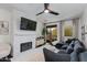 Cozy living room with a fireplace, white brick surround, and access to a balcony at 1411 E Orangewood Ave # 237, Phoenix, AZ 85020