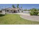 Expansive backyard features a refreshing pool, lush lawn, and stylish patio ideal for outdoor living at 1444 E Boston St, Chandler, AZ 85225
