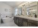 Elegant bathroom boasts dual sink vanity, soaking tub, and stylish fixtures at 1444 E Boston St, Chandler, AZ 85225