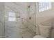 Bright bathroom features a glass enclosed shower with luxurious tile work at 1444 E Boston St, Chandler, AZ 85225
