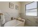 Bathroom featuring an elegant standalone tub, marble accents, and a bright window at 1444 E Boston St, Chandler, AZ 85225