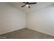 Clean, simple bedroom with neutral carpet, ceiling fan, and minimal decor at 1444 E Boston St, Chandler, AZ 85225